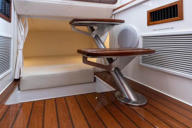 Middle Path Yacht Photos Pics Interior of 2023 MJM Yachts 4, featuring wooden steps and a cozy cabin space.