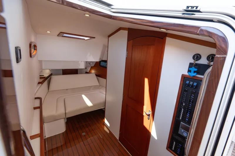 Middle Path Yacht Photos Pics Interior of 2023 MJM Yachts 4, featuring elegant wood finishes and cozy seating.