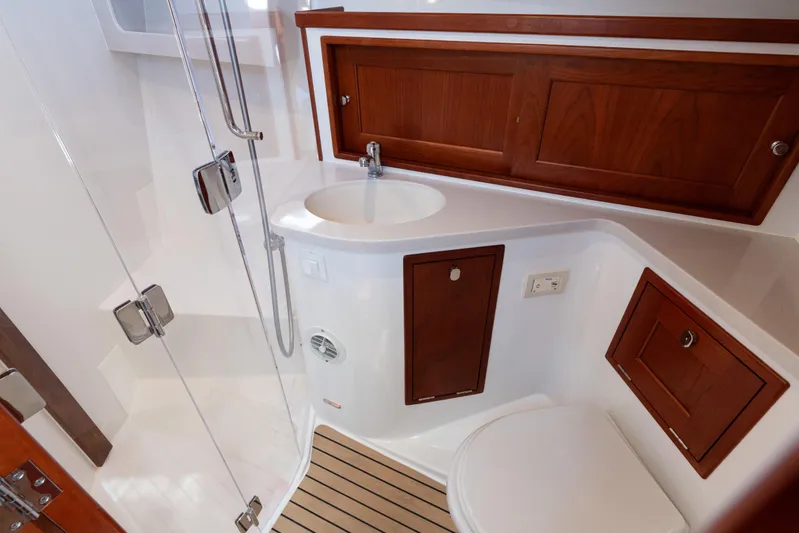Middle Path Yacht Photos Pics Luxurious bathroom in 2023 MJM Yachts 4, featuring wood accents and modern fixtures.