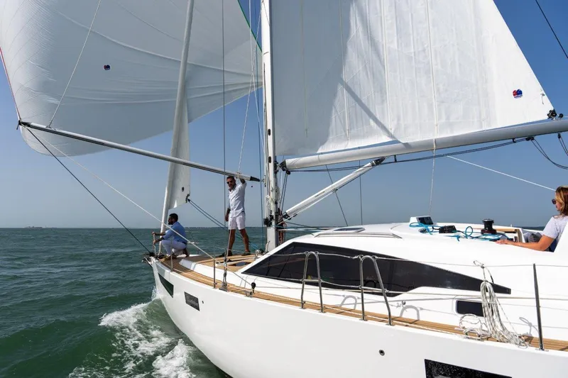 Off The Grid Yacht Photos Pics 2024 Southerly 420 yacht sailing on open water with crew on deck.