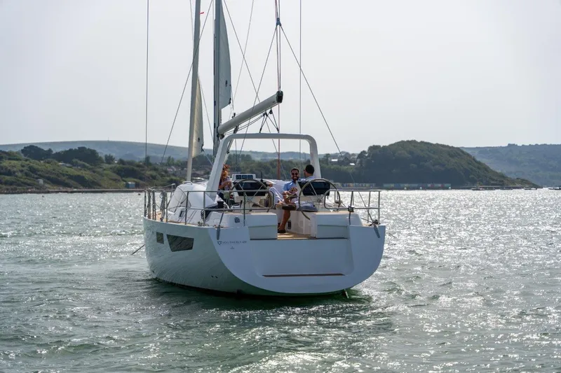 Off The Grid Yacht Photos Pics 2024 Southerly 420 sailboat cruising on a sunny day with scenic coastal backdrop.