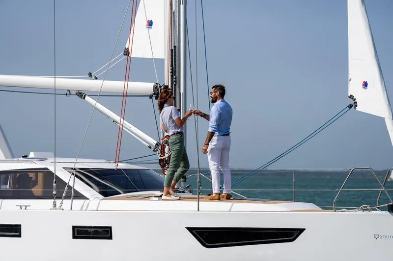 Off The Grid Yacht Photos Pics Couple on deck of 2024 Southerly 420 yacht, enjoying a sunny day at sea.