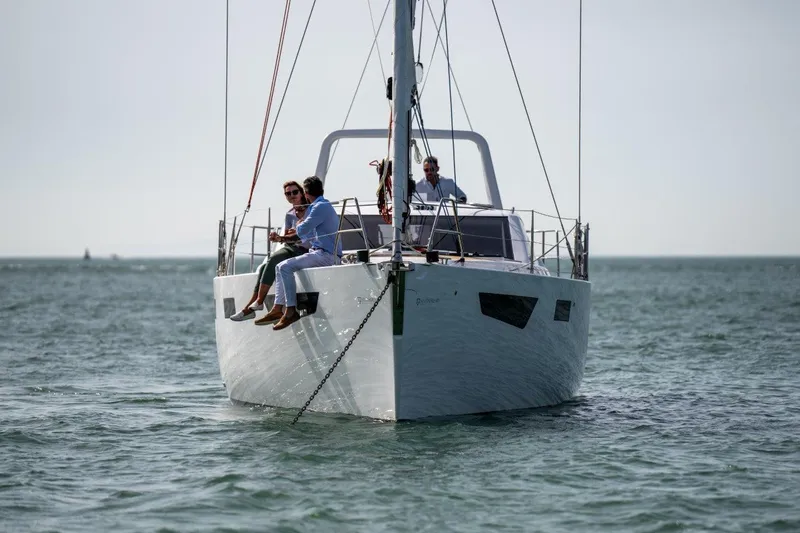 Off The Grid Yacht Photos Pics 2024 Southerly 420 yacht sailing with passengers on a calm sea.