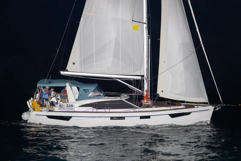 Off The Grid Yacht Photos Pics 2024 Southerly 420 sailboat sailing at night with illuminated sails.