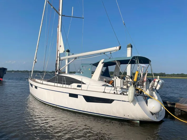 Off The Grid Yacht Photos Pics 2024 Southerly 420 sailboat docked on calm water under clear blue sky.