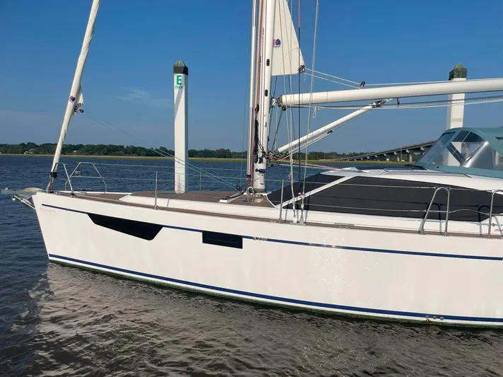 Off The Grid Yacht Photos Pics 2024 Southerly 420 sailboat docked on calm water under clear blue sky.