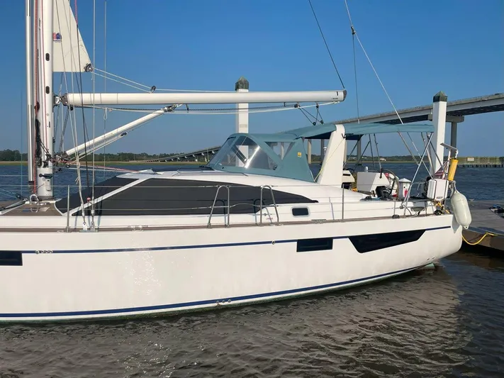 Off The Grid Yacht Photos Pics 2024 Southerly 420 sailboat docked near a bridge on a sunny day.