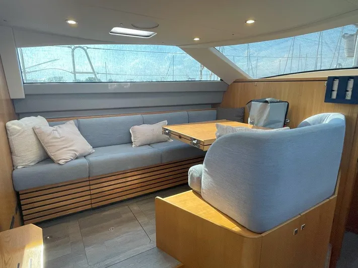 Off The Grid Yacht Photos Pics Luxurious interior of 2024 Southerly 420 yacht with plush seating and wooden accents.
