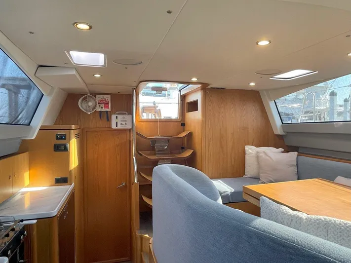 Off The Grid Yacht Photos Pics 2024 Southerly 420 yacht interior with modern wood finish and cozy seating area.