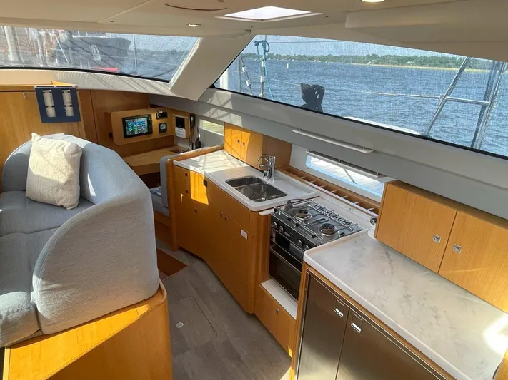 Off The Grid Yacht Photos Pics Luxurious interior of 2024 Southerly 420 yacht with modern kitchen and seating area.