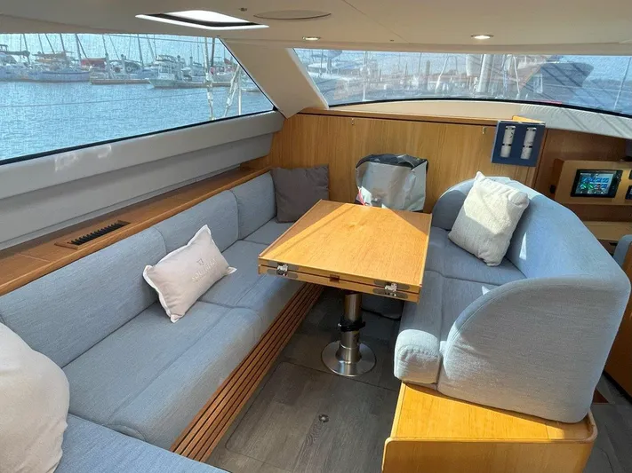 Off The Grid Yacht Photos Pics Luxurious interior of 2024 Southerly 420 yacht with cozy seating and wooden table.