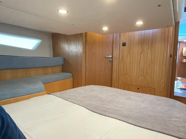 Off The Grid Yacht Photos Pics 2024 Southerly 420 yacht interior cabin with wooden finish and cozy bedding.