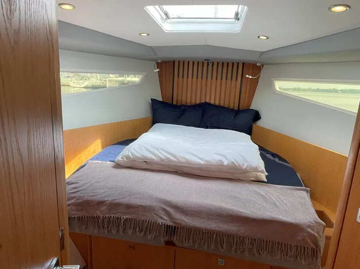 Off The Grid Yacht Photos Pics Luxurious cabin interior of 2024 Southerly 420 yacht with cozy bedding and natural light.