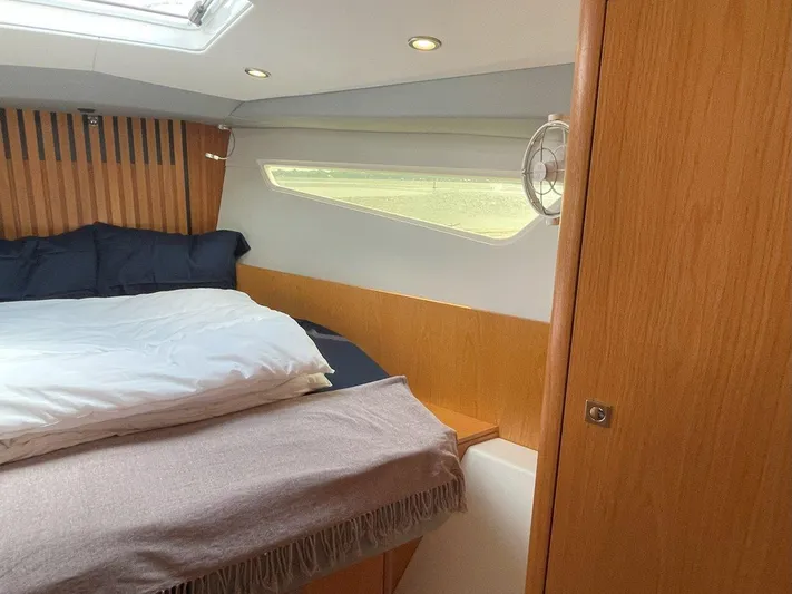 Off The Grid Yacht Photos Pics 2024 Southerly 420 yacht cabin with cozy bed and wooden interior.