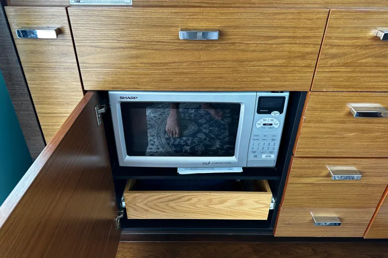Salty Sam Yacht Photos Pics Built-in Sharp microwave in Tiara 5000 Coupe, 2014 model, wooden cabinetry.