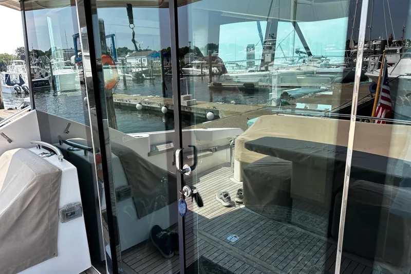 Salty Sam Yacht Photos Pics 2014 Tiara 5000 Coupe yacht interior with marina view through glass doors.
