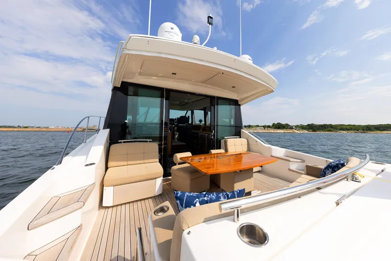 Salty Sam Yacht Photos Pics 2014 Tiara 5000 Coupe yacht with spacious deck and seating on open water.