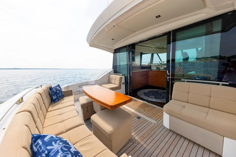 Salty Sam Yacht Photos Pics Luxurious 2014 Tiara 5000 Coupe yacht with elegant outdoor seating and ocean view.