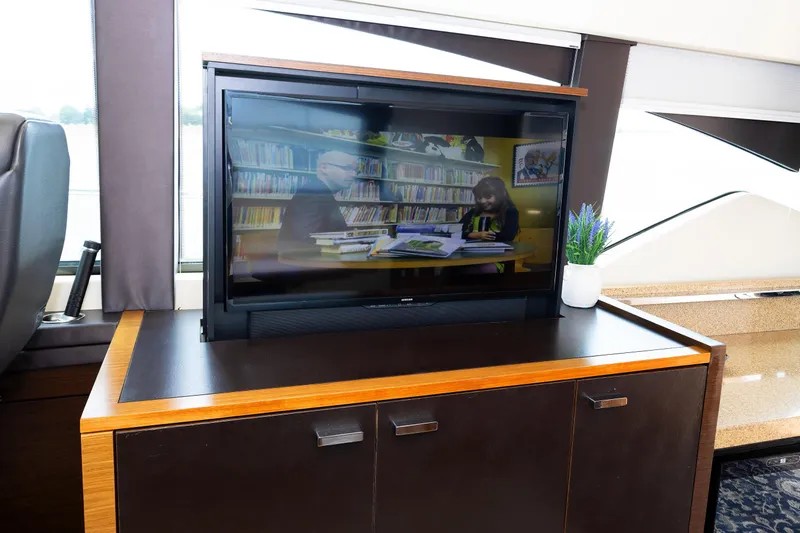 Salty Sam Yacht Photos Pics Interior of 2014 Tiara 5000 Coupe with TV and potted plant on cabinet.