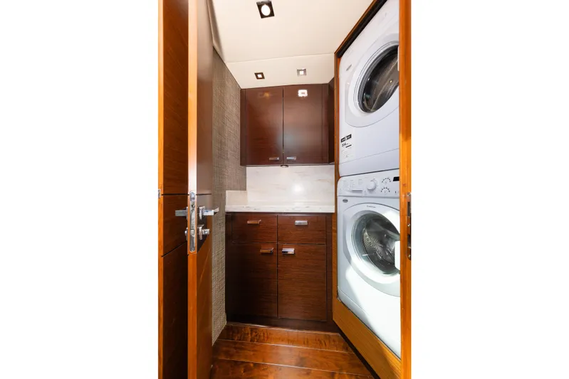 Salty Sam Yacht Photos Pics Compact laundry area in 2014 Tiara 5000 Coupe with stacked washer and dryer.