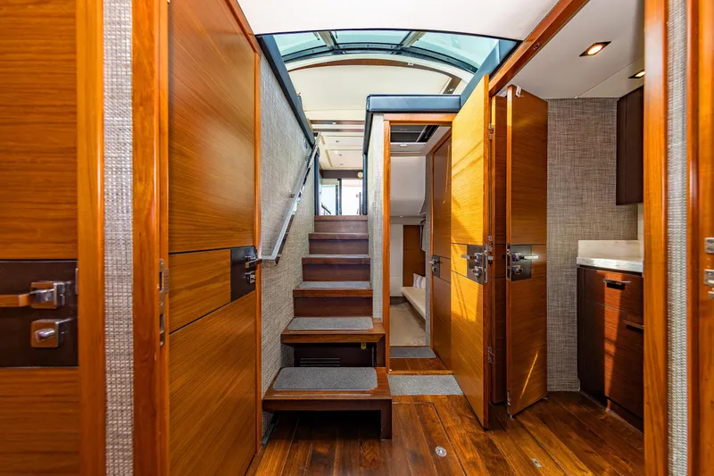 Salty Sam Yacht Photos Pics Luxurious interior of 2014 Tiara 5000 Coupe yacht with wooden finishes and modern design.