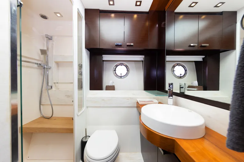 Salty Sam Yacht Photos Pics Luxurious bathroom interior of 2014 Tiara 5000 Coupe yacht with modern fixtures.