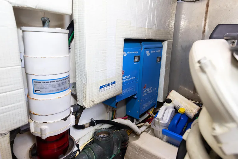 Salty Sam Yacht Photos Pics Engine room of 2014 Tiara 5000 Coupe with battery chargers and diesel filter.