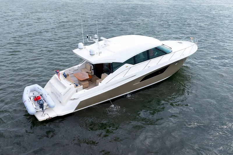 Salty Sam Yacht Photos Pics 2014 Tiara 5000 Coupe yacht on water, featuring sleek design and spacious deck.