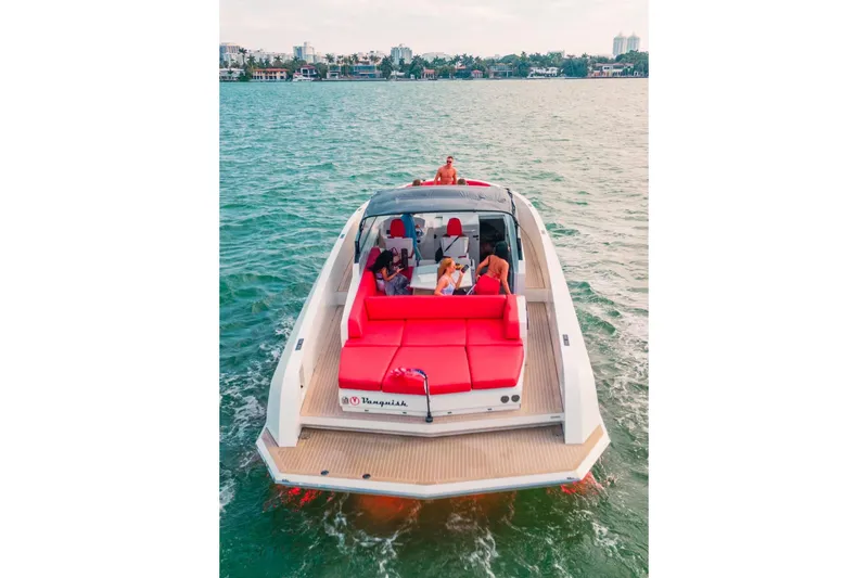  Yacht Photos Pics 2016 Vanquish Yachts 48 cruising with passengers, featuring vibrant red seating and sleek design.