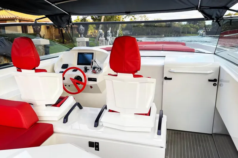  Yacht Photos Pics Luxurious 2016 Vanquish Yachts 48 interior with red seating and modern helm controls.