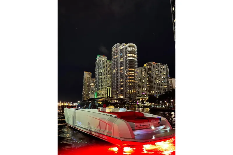  Yacht Photos Pics Vanquish Yachts 48, 2016 model, illuminated at night against city skyline.