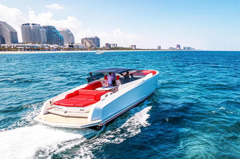  Yacht Photos Pics 2016 Vanquish Yachts 48 cruising near a coastal city skyline.