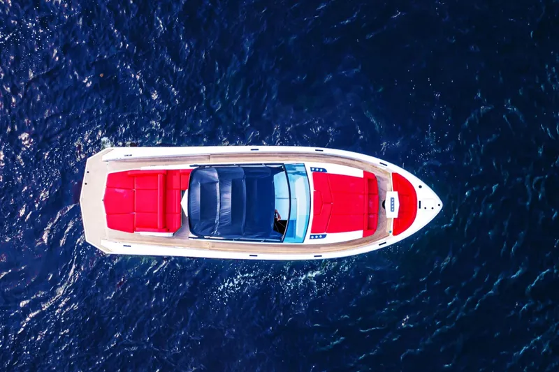  Yacht Photos Pics Aerial view of 2016 Vanquish Yachts 48 with red seating on blue water.