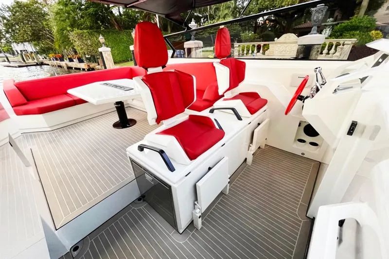  Yacht Photos Pics 2016 Vanquish Yachts 48 interior with red seating and modern helm.
