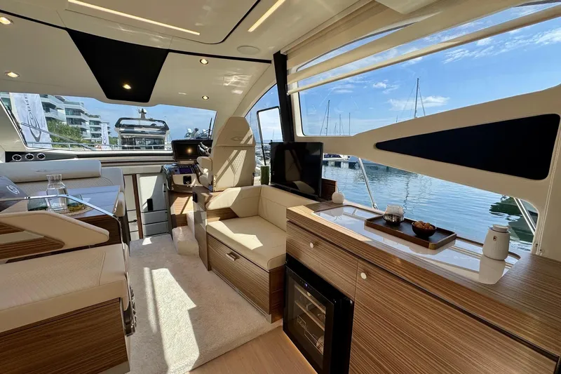  Yacht Photos Pics Luxurious interior of 2025 Cobrey 42 FLY yacht with modern furnishings and scenic marina view.