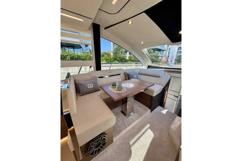  Yacht Photos Pics Luxurious interior of 2025 Cobrey 42 FLY yacht with elegant seating and modern design.