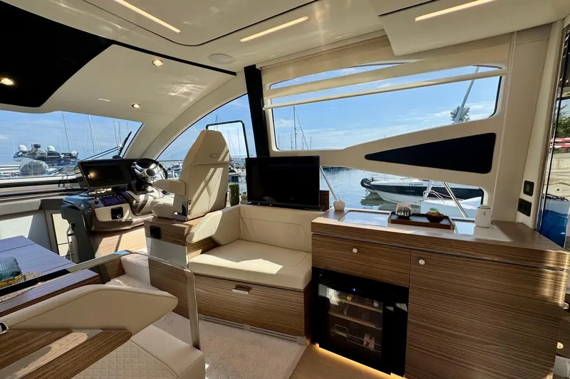  Yacht Photos Pics Luxurious interior of 2025 Cobrey 42 FLY yacht with modern design and marina view.