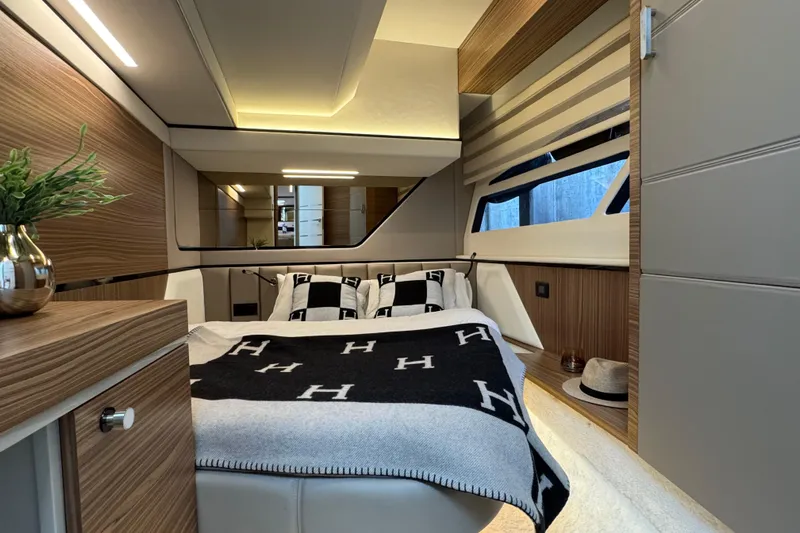  Yacht Photos Pics Luxurious interior of 2025 Cobrey 42 FLY yacht with modern design and cozy bedding.