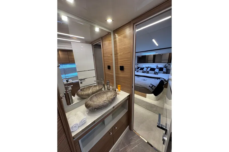  Yacht Photos Pics Luxurious bathroom and bedroom interior of 2025 Cobrey 42 FLY yacht, featuring modern design elements.