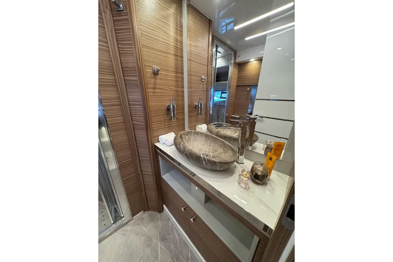  Yacht Photos Pics Luxurious bathroom interior of 2025 Cobrey 42 FLY yacht with modern fixtures and elegant design.