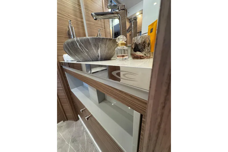  Yacht Photos Pics Luxurious bathroom vanity on 2025 Cobrey 42 FLY yacht with modern sink and elegant decor.