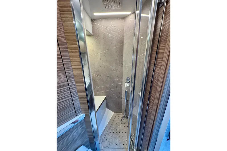  Yacht Photos Pics Luxurious bathroom in 2025 Cobrey 42 FLY yacht with modern shower design.