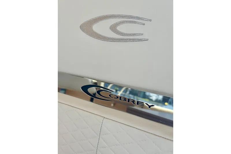  Yacht Photos Pics 2025 Cobrey 42 FLY yacht interior with logo detail on white upholstery.