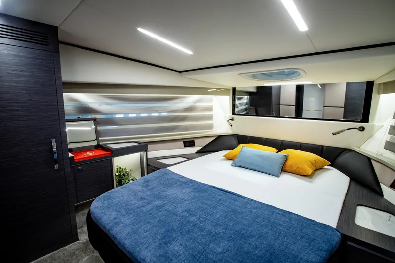  Yacht Photos Pics Luxurious bedroom interior of 2025 Cobrey 42 FLY yacht with modern design and cozy bedding.