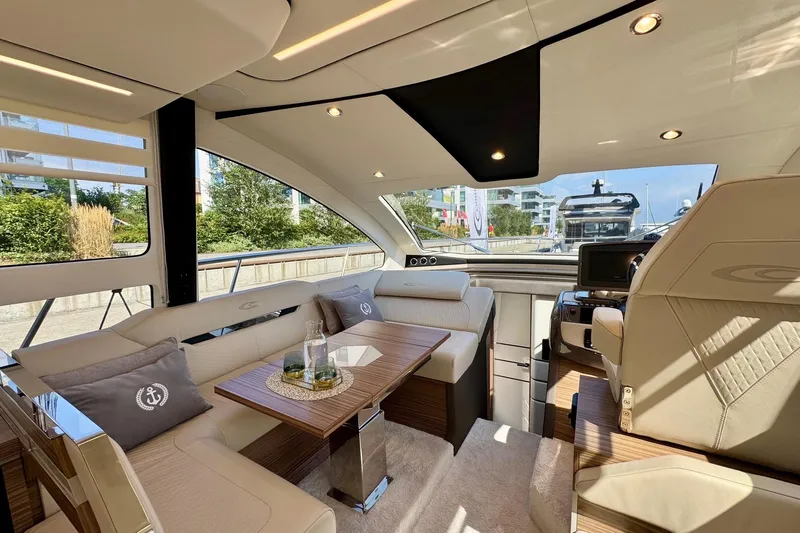  Yacht Photos Pics Luxurious interior of 2025 Cobrey 42 FLY yacht with elegant seating and modern design.