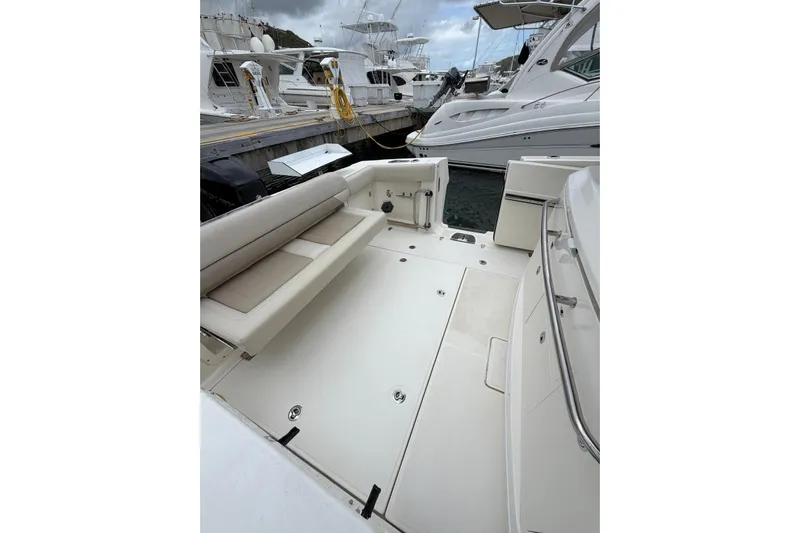  Yacht Photos Pics 2022 Boston Whaler 380 Outrage boat interior with seating, docked at marina.