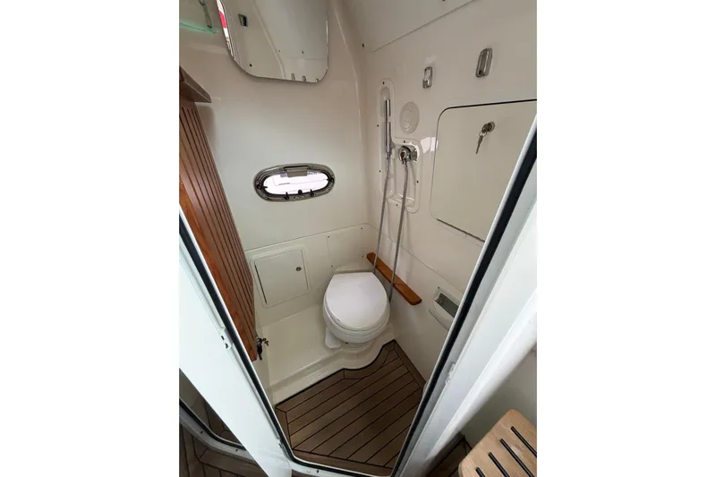  Yacht Photos Pics 2022 Boston Whaler 380 Outrage bathroom with modern fixtures and wooden accents.