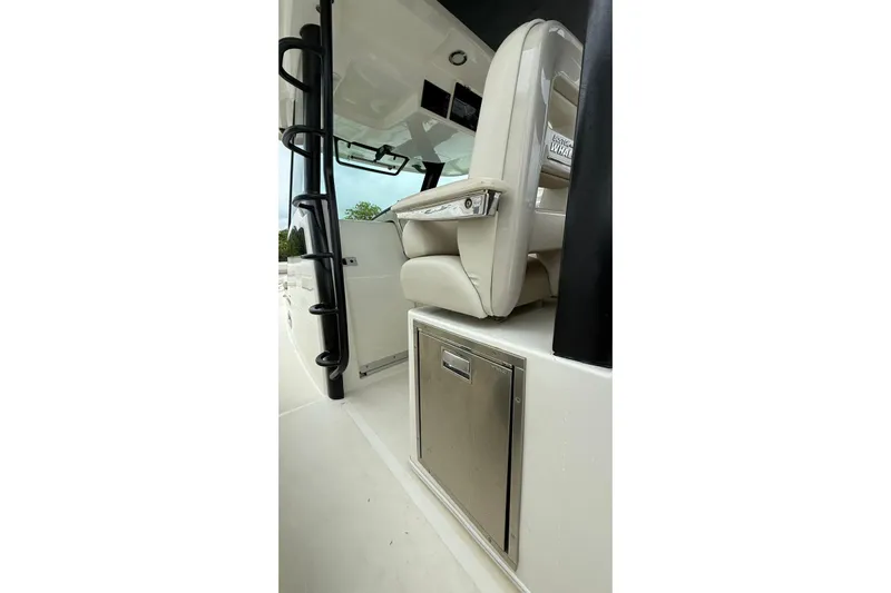  Yacht Photos Pics 2022 Boston Whaler 380 Outrage interior with seating and storage compartment.