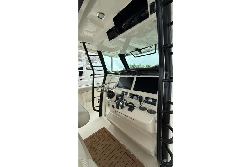  Yacht Photos Pics 2022 Boston Whaler 380 Outrage helm with modern controls and sleek design.