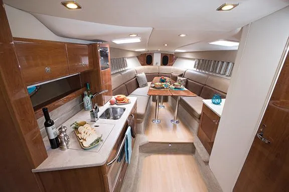 Wet Benefits Yacht Photos Pics Manufacturer Provided Image: Luxurious interior of 2015 Formula 370 Super Sport yacht with kitchen and dining area.